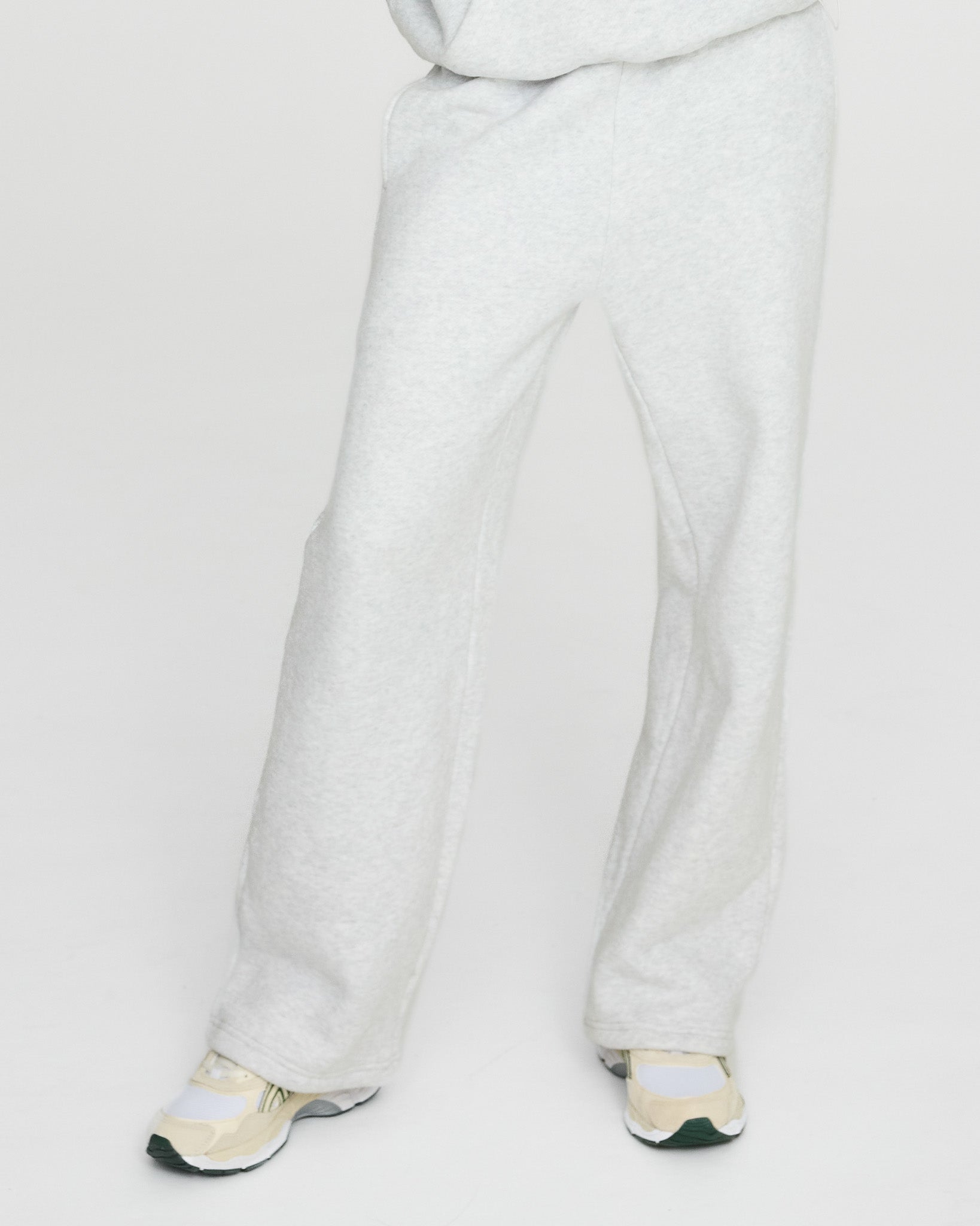 grey pants worn by a person on a white background