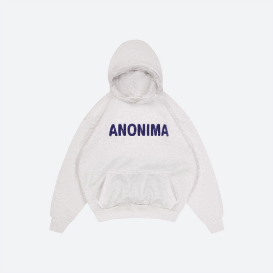 Flat Lay of heather grey anonima hood with 'ANONIMA' text on a light gray background