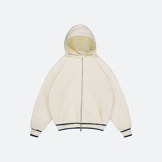 Flat Lay of White hoodie with navy trim on a light gray background